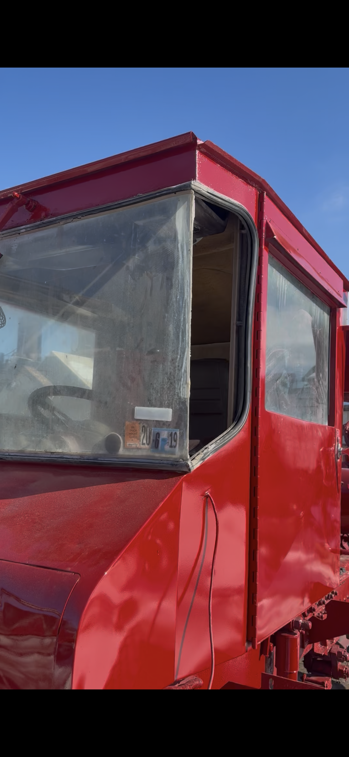 Old side glass — red construction vehicle